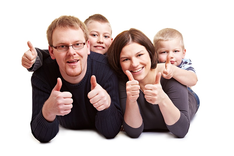 happy thumbs up family with great teeth